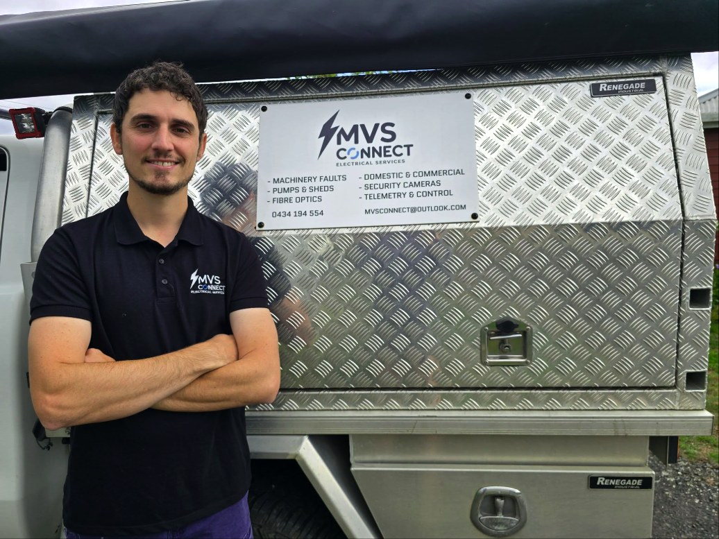 Mark, owner of MVS Connect, standing beside his signed work ute in North-West Tasmania