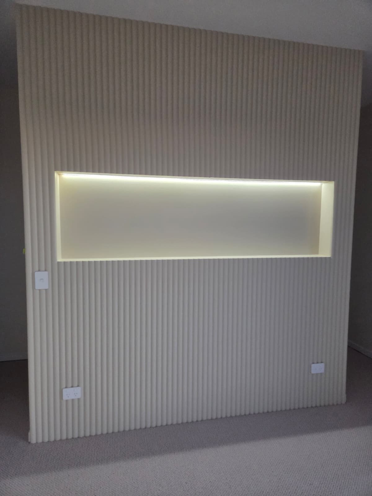 Fluted feature wall with concealed LED strip lighting in a niche, wired by MVS Connect