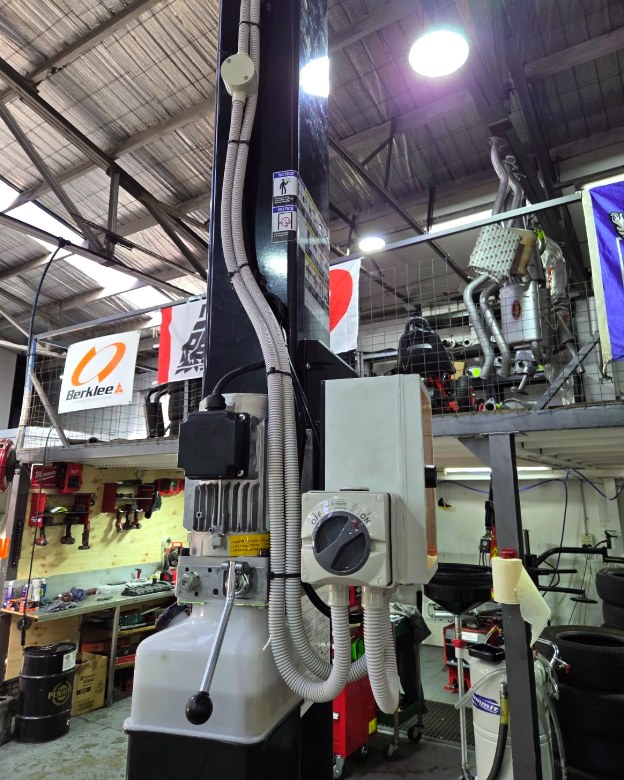 Two-post vehicle hoist electrically installed and commissioned in a busy mechanical workshop by MVS Connect